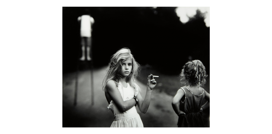 Sally Mann's daughter Jessie with a candy cigarette. "Viewers who knew nothing about us interpreted our lives, and the images were scrutinized under the mantle of scholarship or god-haunted righteousness," the photographer writes in her memoir.